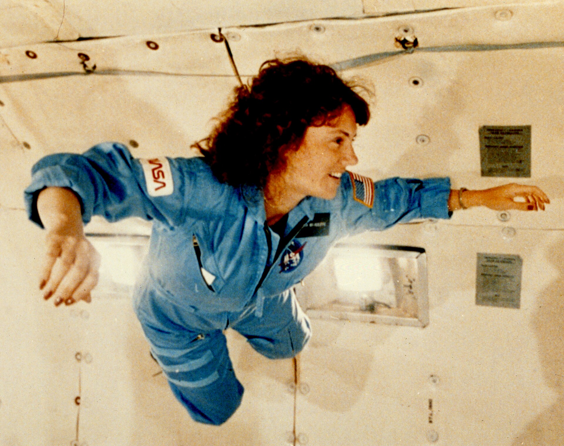 Christa McAuliffe floating inside a NASA KC-135 aircraft during a parabolic flight.