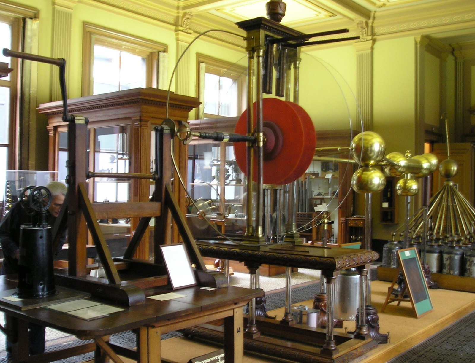 Large historic electrostatic generator with glass disks and conducting terminals in the Teylers Museum.