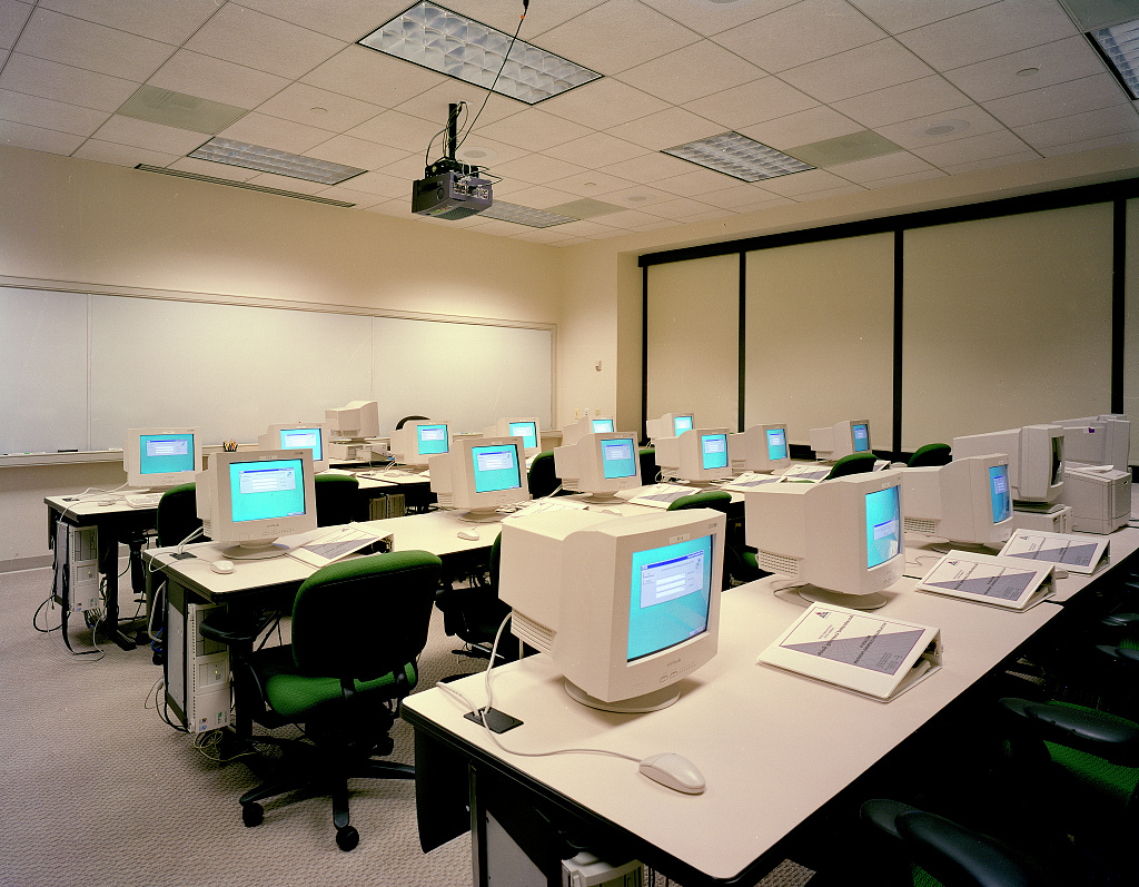 Students learning at desktop computers in a computer training room